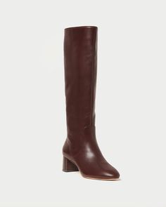 Tall shaft boot with a low heel in espresso brown Italian vachetta leather. Features a padded footbed with gold stamped logo. Almond toe, pulls on. 2 inch heel. Size (US) Shaft Height Calf Circumference 5 15.28" 14.49" 5.5 15.37" 14.67" 6 15.47" 14.84" 6.5 15.57" 15.02" 7 15.67" 15.20" 7.5 15.76" 15.37" 8 15.87" 15.55" 8.5 15.96" 15.73" 9 16.06" 15.91" 9.5 16.16" 16.11" 10 16.26" 16.26" 10.5 16.36" 16.48" 11 16.46" 16.61" 11.5 16.56" 16.8" 12 16.65" 16.97" Brown Knee High Boots, Low Heel Boots, Espresso Brown, Black Boots Tall, Thigh Boot, Tall Boot, Leather Pieces, New Sneakers, Sport Sandals