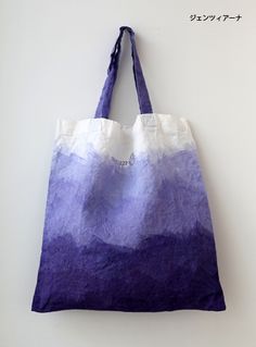 a purple and white bag hanging on the wall