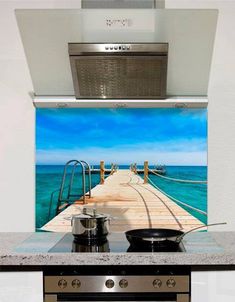 a stove top oven sitting inside of a kitchen next to a wall mounted range hood