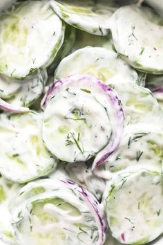 cucumber salad with dill and yogurt dressing in a white bowl