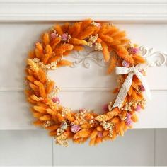 an orange wreath is hanging on the wall