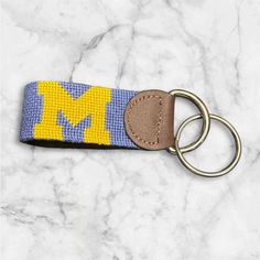 a keychain with the letter m on it