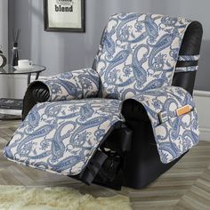 a blue and white reclining chair in a room with a rug on the floor