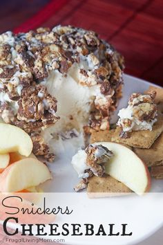 an apple and cheese ball on a plate with crackers