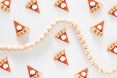 several slices of pizza with marshmallows arranged around them on a white surface