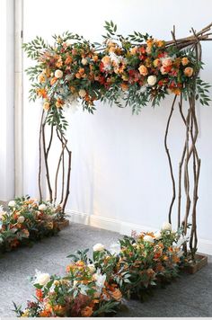 an arch made out of branches and flowers