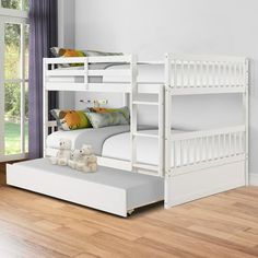 a white bunk bed sitting on top of a hard wood floor next to a window