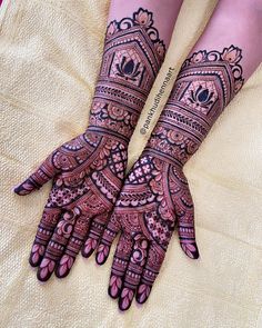 two hands with henna designs on them