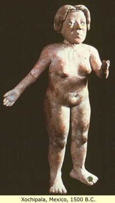 an image of a statue of a woman holding something in her right hand and looking at the camera