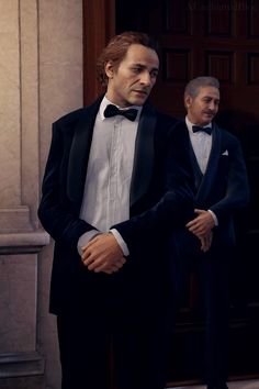 two men in tuxedos standing next to each other