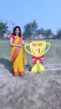 a woman standing next to a sign that says you are 1