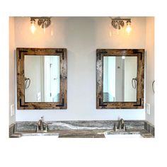 two bathroom sinks with mirrors above them in a white walled room, one is made out of wood and the other has metal faucets on both sides