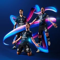 three soccer players in black uniforms are posing for the camera with their arms spread out