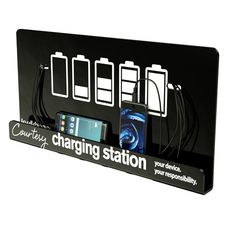 a charging station with three cell phones on it