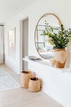 a living room filled with furniture and a large mirror on the wall next to it