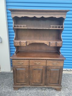 an old wooden hutch with two doors and drawers