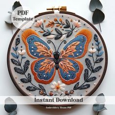 the embroidery pattern is designed to look like a butterfly with orange and blue wings on it