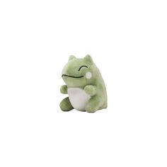 a green stuffed animal sitting on top of a white surface