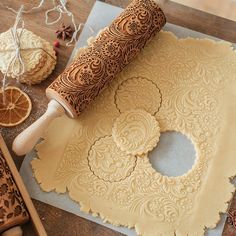 a roll of wax paper sitting on top of a table next to oranges and other items