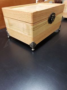 a wooden box sitting on top of a black table