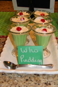 small desserts are arranged on a plate with a sign that says who pudding?