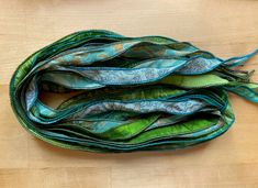 several pieces of fabric sitting on top of a wooden table