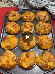 a pan filled with muffins sitting on top of a red table