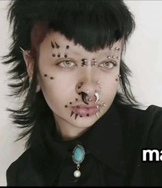 a woman with black hair and piercings on her face