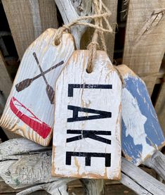 two wooden signs that say canoe and one is painted red, white, and blue