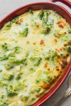 a casserole dish with broccoli and cheese in it on a table