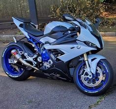 a silver and blue motorcycle parked on the street