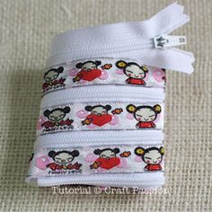 three pieces of white fabric with mickey and minnie mouses printed on the side, one is