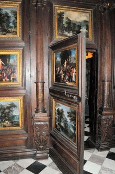 an ornately decorated room with paintings on the walls and floor, along with black and white checkered floors