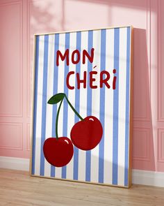 a painting with two cherries on it in front of a pink wall that says mon cher