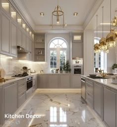 a large kitchen with marble counter tops and gold accents on the ceiling, along with an arched window