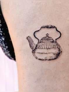 a black and white photo of a teapot tattoo