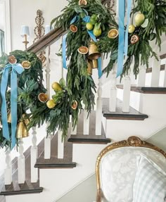 christmas wreaths are hanging on the banister