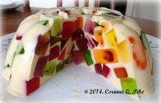 a colorful cake is cut into pieces on a plate