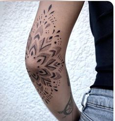 a woman's arm with an intricate tattoo design on the left side of her body