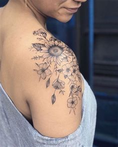 a woman with a sunflower tattoo on her shoulder