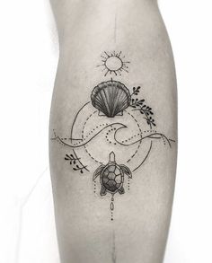 a black and white photo of a tattoo with a turtle on it's leg