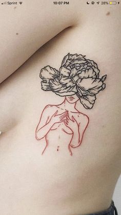 a woman with a flower tattoo on her stomach