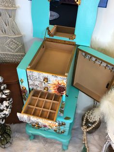 an assortment of jewelry boxes sitting on top of a white furnishing floor in front of a mirror