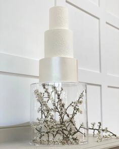 a white wedding cake sitting on top of a table