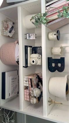 the shelves are organized with toilet paper and other decorative items, including rolls of tape