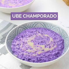 two bowls filled with purple food on top of a white table cloth and the words, ube champoado