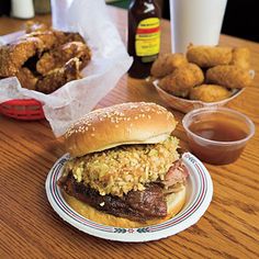 a plate with a sandwich and some fried food on it