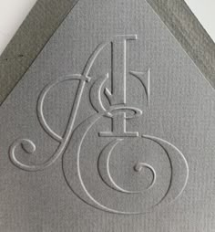 the initials on the side of a building are etched in silver paper with swirly lines