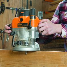 a person using a driller on a piece of wood