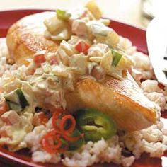 a red plate topped with rice and chicken